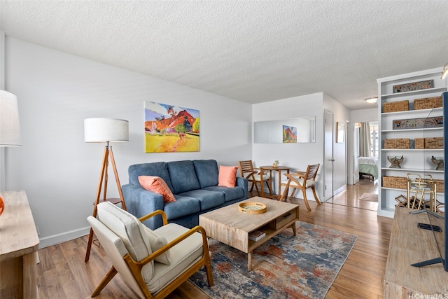 1720 Ala Moana Blvd Unit 1101B, Honolulu, HI 96815 - living room featuring a textured ceiling and light wood-style floors