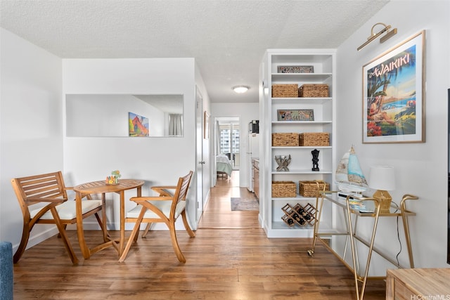 1720 Ala Moana Blvd Unit 1101B, Honolulu, HI 96815 - dining area with wood finished floors, a textured ceiling, and built in features