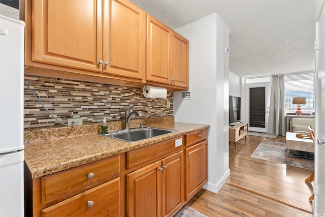 1720 Ala Moana Blvd Unit 1101B, Honolulu, HI 96815 - kitchen with light wood-style floors, tasteful backsplash, freestanding refrigerator, light countertops, and a textured ceiling