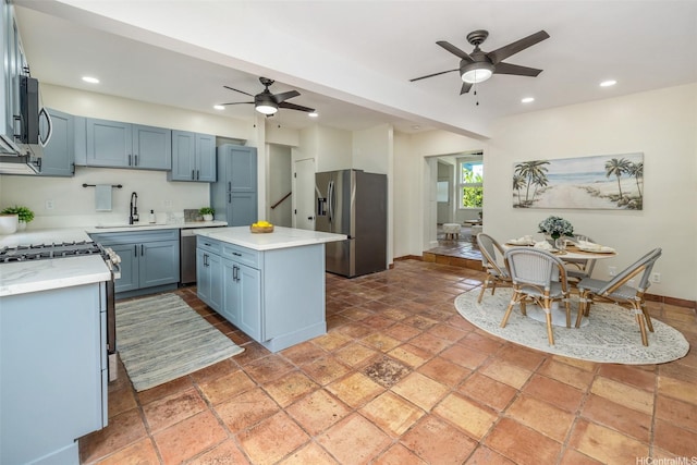 54-290 Kawaipuna Pl, Hauula, HI 96717 - kitchen featuring appliances with stainless steel finishes, a ceiling fan, recessed lighting, a kitchen island, and blue cabinetry