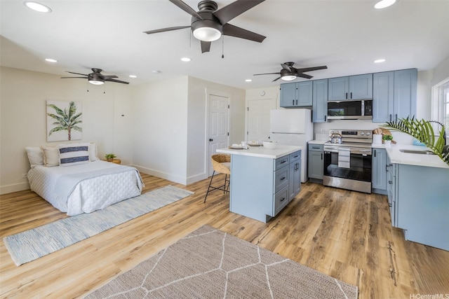 54-290 Kawaipuna Pl, Hauula, HI 96717 - kitchen featuring appliances with stainless steel finishes, ceiling fan, a breakfast bar, light countertops, and a kitchen island