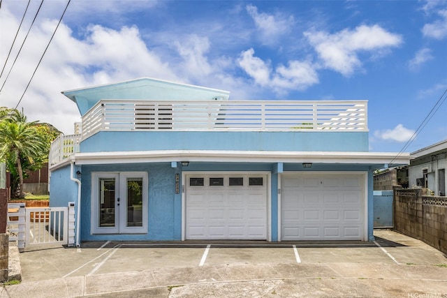 54-290 Kawaipuna Pl, Hauula, HI 96717 - view of front facade with a balcony, concrete driveway, stucco siding, and an attached garage