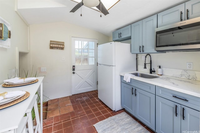 54-290 Kawaipuna Pl, Hauula, HI 96717 - kitchen featuring stainless steel microwave, freestanding refrigerator, ceiling fan, lofted ceiling, and blue cabinets