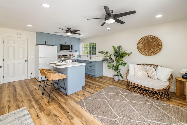 54-290 Kawaipuna Pl, Hauula, HI 96717 - kitchen featuring stainless steel appliances, light countertops, a kitchen breakfast bar, ceiling fan, and a center island