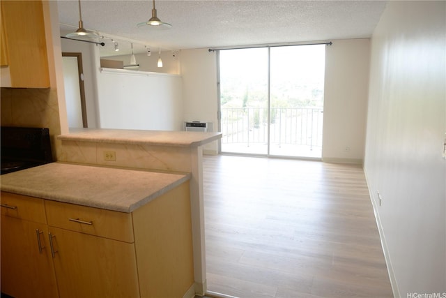 98-1038 Moanalua Rd Unit 7-1706, Aiea, HI 96701 - kitchen with stove, expansive windows, light countertops, light wood-style floors, and a textured ceiling