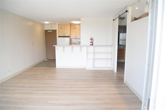 98-1038 Moanalua Rd Unit 7-1706, Aiea, HI 96701 - kitchen featuring light wood-style floors, light brown cabinetry, light countertops, fridge, and a peninsula