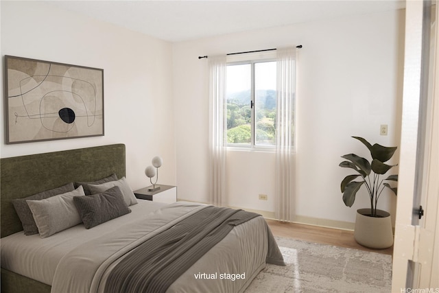 98-1038 Moanalua Rd Unit 7-1706, Aiea, HI 96701 - bedroom featuring wood finished floors and baseboards
