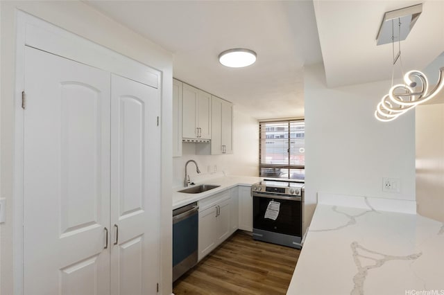 1910 Ala Moana Blvd Unit 7D, Honolulu, HI 96815 - kitchen featuring appliances with stainless steel finishes, dark wood-type flooring, light stone counters, and white cabinets