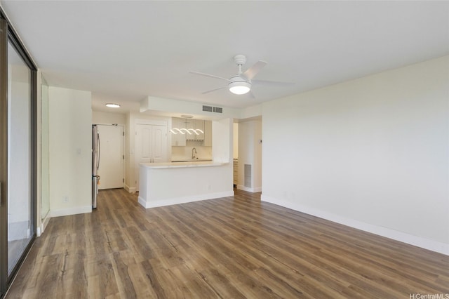 1910 Ala Moana Blvd Unit 7D, Honolulu, HI 96815 - unfurnished living room featuring dark wood-style floors and a ceiling fan