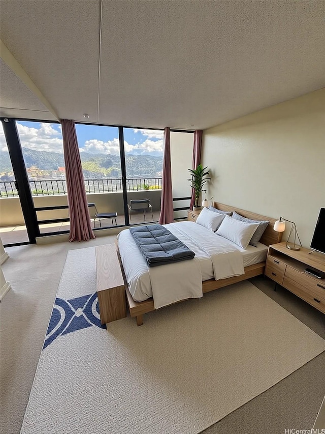 2240 Kuhio Ave Unit 3801, Honolulu, HI 96815 - carpeted bedroom with access to outside, a textured ceiling, and expansive windows