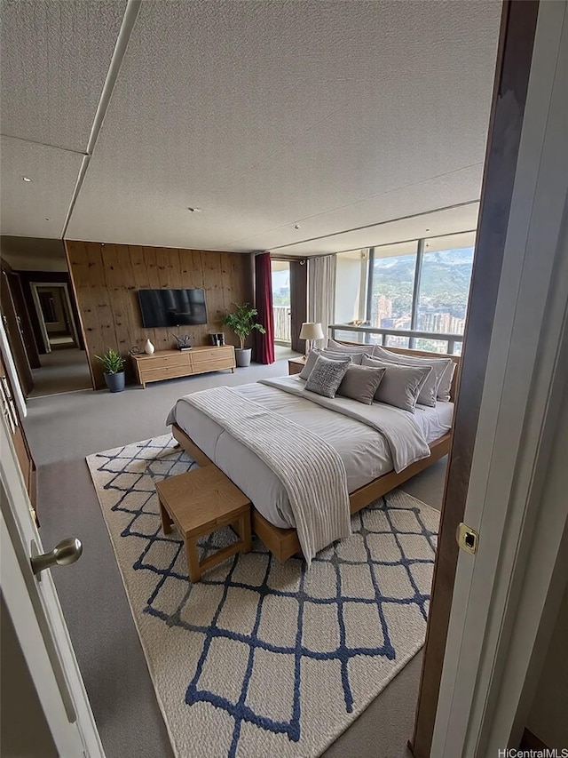 2240 Kuhio Ave Unit 3801, Honolulu, HI 96815 - carpeted bedroom with wood walls and a textured ceiling