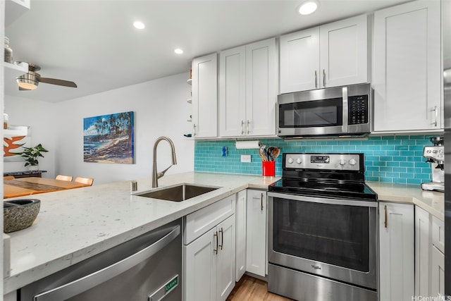 46-109 Konohiki St Unit 3934, Kaneohe, HI 96744 - kitchen with appliances with stainless steel finishes, light stone countertops, tasteful backsplash, recessed lighting, and open shelves