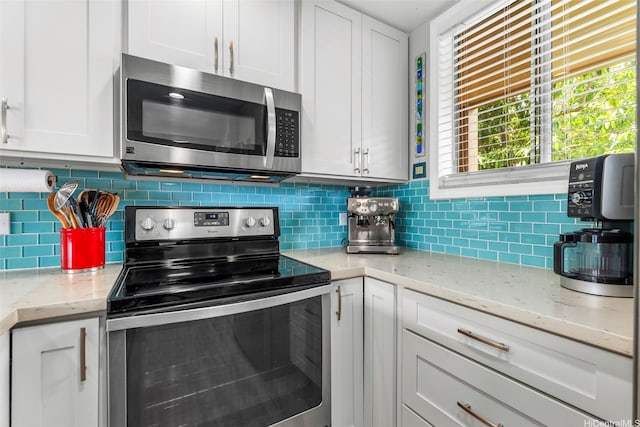 46-109 Konohiki St Unit 3934, Kaneohe, HI 96744 - kitchen featuring stainless steel appliances, white cabinets, and decorative backsplash