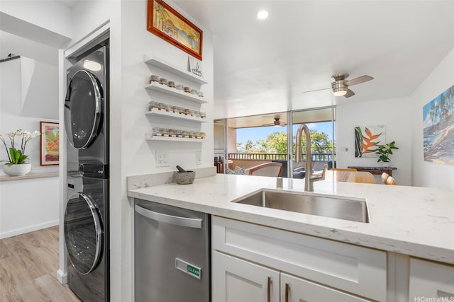 46-109 Konohiki St Unit 3934, Kaneohe, HI 96744 - kitchen featuring dishwasher, stacked washing machine and dryer, light wood-style flooring, light stone countertops, and a ceiling fan