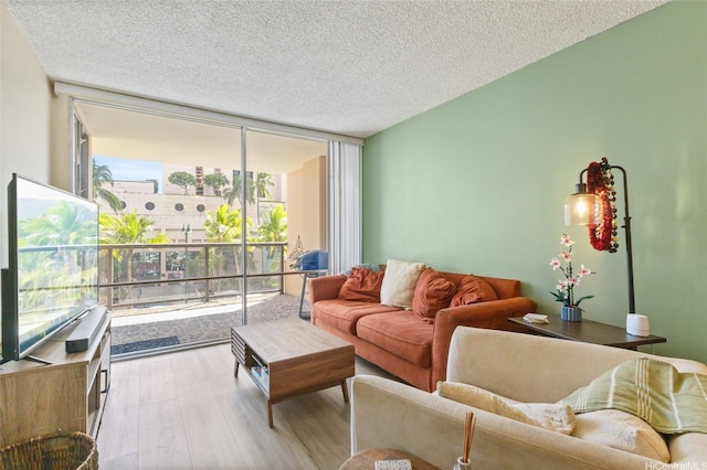 1684 Ala Moana Blvd Unit 251, Honolulu, HI 96815 - living area with a wall of windows, wood finished floors, and a textured ceiling
