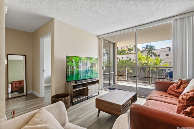 1684 Ala Moana Blvd Unit 251, Honolulu, HI 96815 - living room featuring floor to ceiling windows, wood finished floors, and a textured ceiling