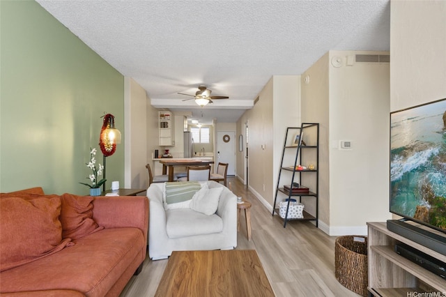 1684 Ala Moana Blvd Unit 251, Honolulu, HI 96815 - living room featuring light wood-type flooring, ceiling fan, and a textured ceiling