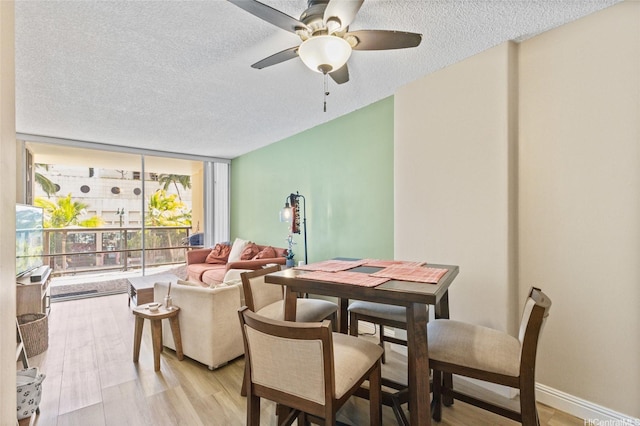 1684 Ala Moana Blvd Unit 251, Honolulu, HI 96815 - dining area with expansive windows, a textured ceiling, a ceiling fan, and light wood-style flooring