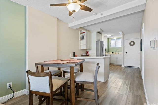 1684 Ala Moana Blvd Unit 251, Honolulu, HI 96815 - dining space featuring ceiling fan, light wood-style flooring, and a textured ceiling