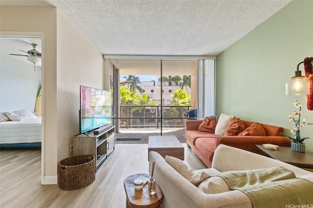 1684 Ala Moana Blvd Unit 251, Honolulu, HI 96815 - living area featuring expansive windows, wood finished floors, a textured ceiling, and a ceiling fan