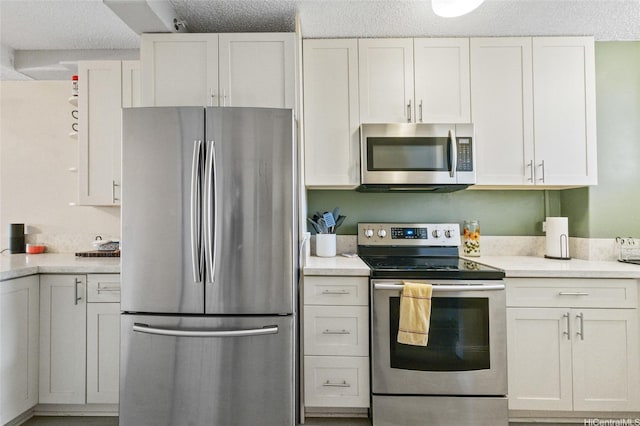 1684 Ala Moana Blvd Unit 251, Honolulu, HI 96815 - kitchen featuring appliances with stainless steel finishes, light countertops, white cabinets, and a textured ceiling