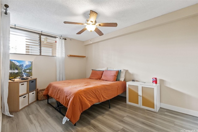 1684 Ala Moana Blvd Unit 251, Honolulu, HI 96815 - bedroom featuring light wood-type flooring, a textured ceiling, and a ceiling fan
