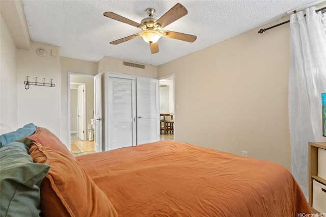 1684 Ala Moana Blvd Unit 251, Honolulu, HI 96815 - tiled bedroom with a closet, ceiling fan, and a textured ceiling