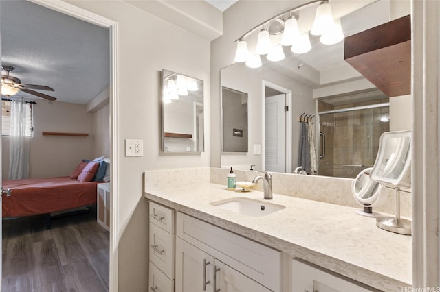 1684 Ala Moana Blvd Unit 251, Honolulu, HI 96815 - bathroom featuring vanity, ensuite bath, wood finished floors, tiled shower, and a ceiling fan