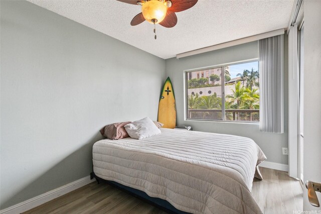 1684 Ala Moana Blvd Unit 251, Honolulu, HI 96815 - bedroom with wood finished floors, a textured ceiling, and a ceiling fan