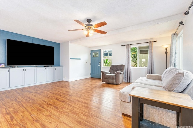 94-170 Apele Pl, Mililani, HI 96789 - living area with light wood finished floors, a ceiling fan, and a textured ceiling