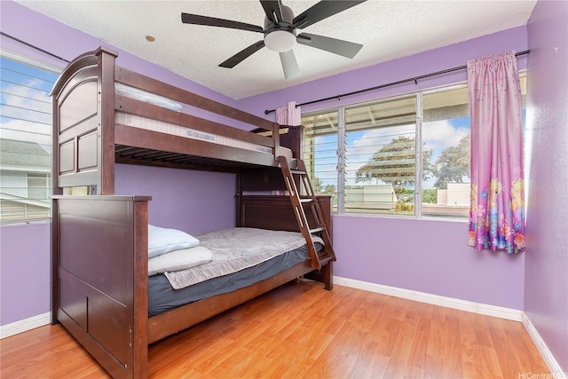 94-170 Apele Pl, Mililani, HI 96789 - bedroom with wood finished floors, a textured ceiling, and ceiling fan