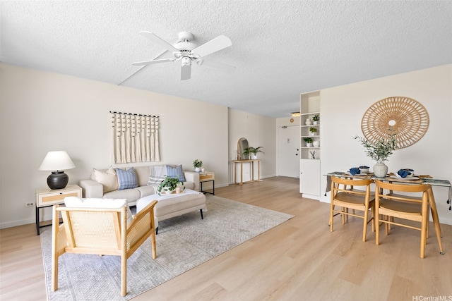 2444 Hihiwai St Unit 902, Honolulu, HI 96826 - living area with ceiling fan, light wood finished floors, and a textured ceiling