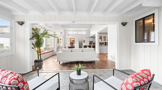 1373 Kaeleku St, Honolulu, HI 96825 - living area with beamed ceiling, healthy amount of natural light, wood finished floors, and a wall mounted air conditioner