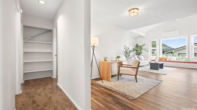 1373 Kaeleku St, Honolulu, HI 96825 - hallway with wood finished floors, an AC wall unit, lofted ceiling, recessed lighting, and a textured ceiling