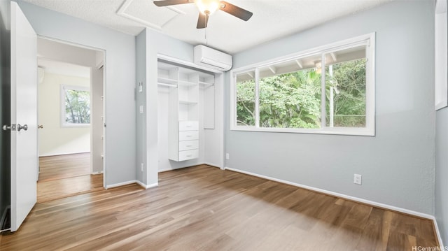 1373 Kaeleku St, Honolulu, HI 96825 - unfurnished bedroom featuring a wall unit AC, wood finished floors, a closet, a ceiling fan, and attic access