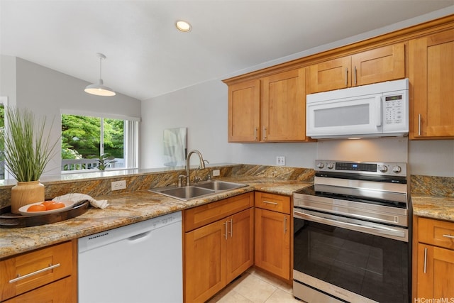 92-1487-A Aliinui Dr Unit 27A, Kapolei, HI 96707 - kitchen featuring white appliances, lofted ceiling, brown cabinetry, light stone countertops, and a peninsula