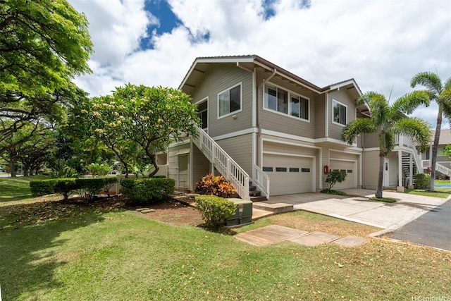 92-1487-A Aliinui Dr Unit 27A, Kapolei, HI 96707 - view of front facade with stairs, an attached garage, driveway, and a front lawn