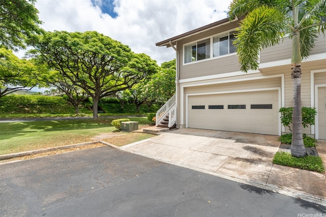 92-1487-A Aliinui Dr Unit 27A, Kapolei, HI 96707 - view of front of house featuring concrete driveway, a garage, stairway, and a front yard