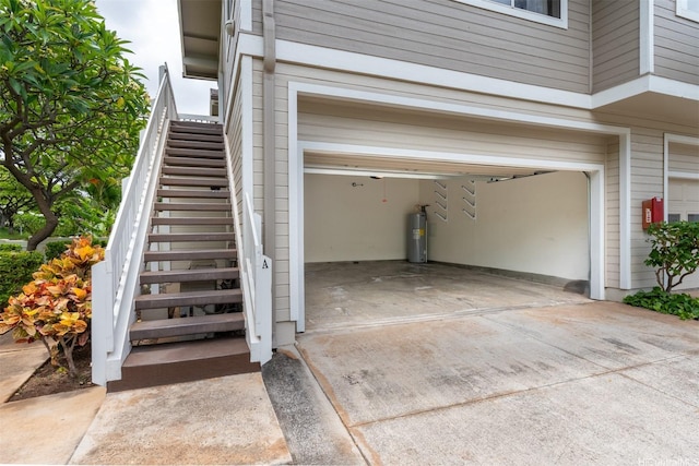 92-1487-A Aliinui Dr Unit 27A, Kapolei, HI 96707 - garage with water heater and driveway