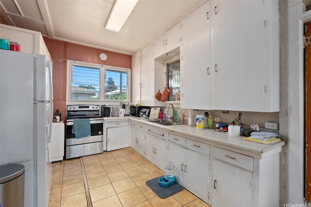1242 16th Ave, Honolulu, HI 96816 - kitchen with stainless steel range with electric cooktop, freestanding refrigerator, white cabinets, light countertops, and light tile patterned floors