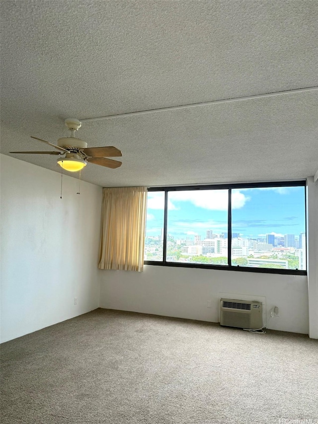 55 S Kukui St Unit D1410, Honolulu, HI 96813 - unfurnished room with carpet flooring, ceiling fan, a textured ceiling, a wall mounted AC, and a view of city