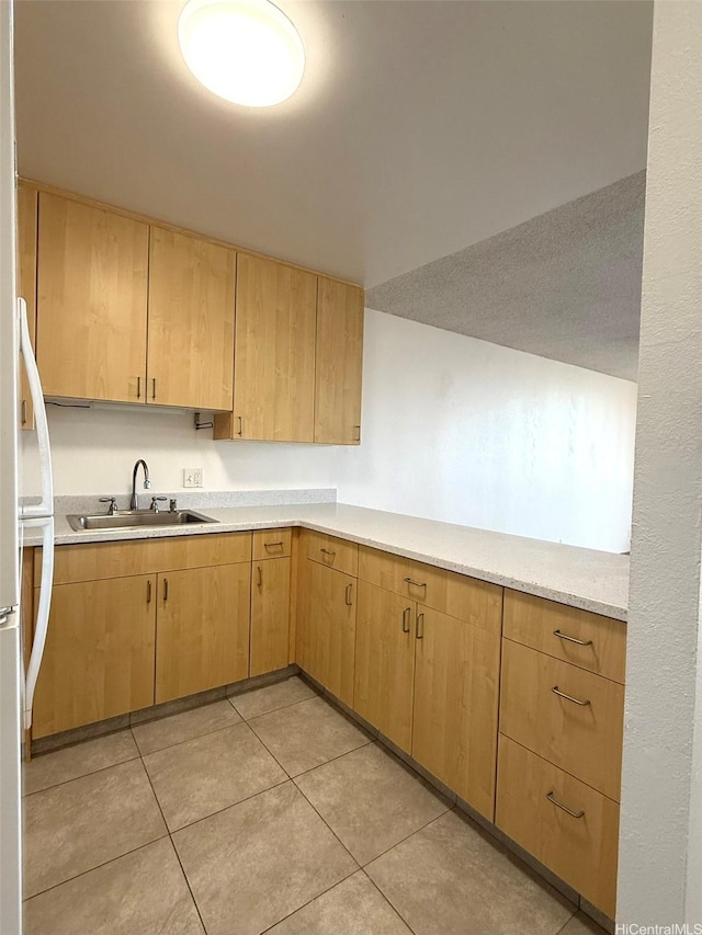 55 S Kukui St Unit D1410, Honolulu, HI 96813 - kitchen featuring light countertops, light tile patterned flooring, freestanding refrigerator, and light brown cabinets