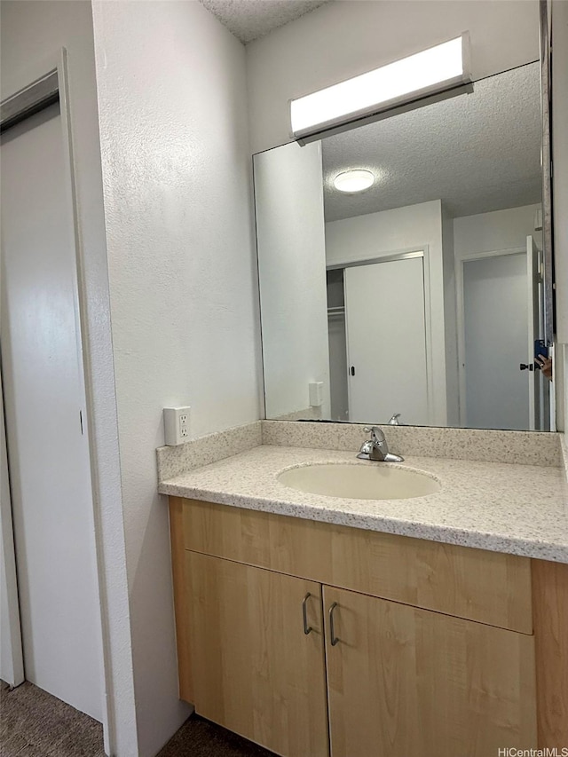 55 S Kukui St Unit D1410, Honolulu, HI 96813 - bathroom featuring a textured ceiling and vanity