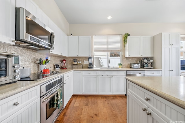 91-1030 Kai Uhu St, Ewa Beach, HI 96706 - kitchen featuring appliances with stainless steel finishes, white cabinets, decorative backsplash, and recessed lighting