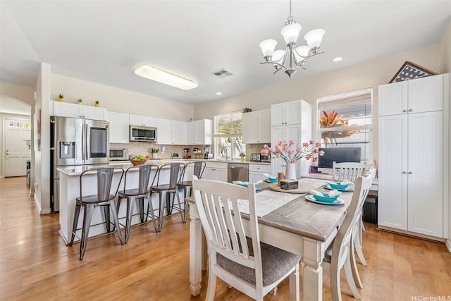 91-1030 Kai Uhu St, Ewa Beach, HI 96706 - dining space featuring a chandelier, light wood-type flooring, recessed lighting, and arched walkways