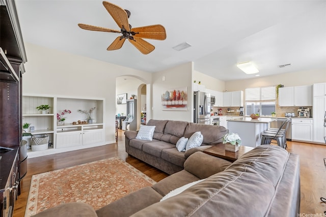 91-1030 Kai Uhu St, Ewa Beach, HI 96706 - living room featuring arched walkways, light wood finished floors, and ceiling fan