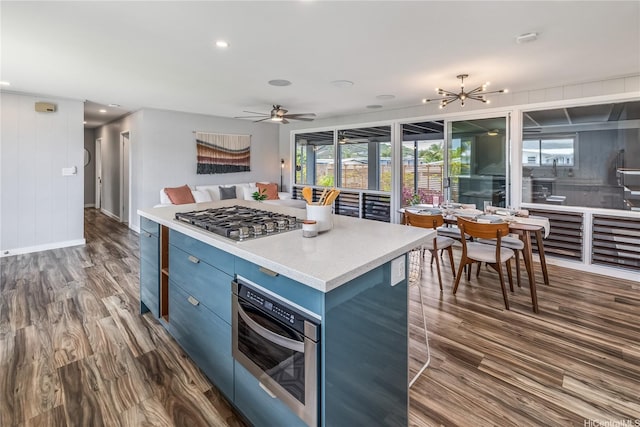 1384 Nanawale Pl, Kailua, HI 96734 - kitchen with stainless steel gas stovetop, blue cabinets, dark wood-style flooring, plenty of natural light, and recessed lighting