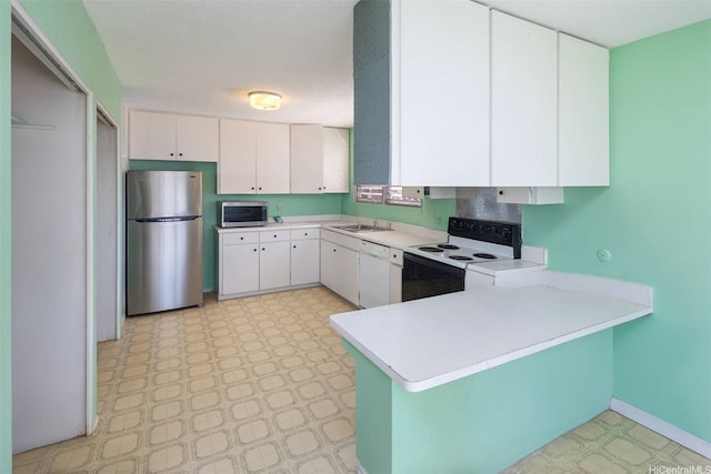 5333 Puahia Pl, Honolulu, HI 96821 - kitchen featuring stainless steel appliances, light flooring, a peninsula, light countertops, and white cabinets