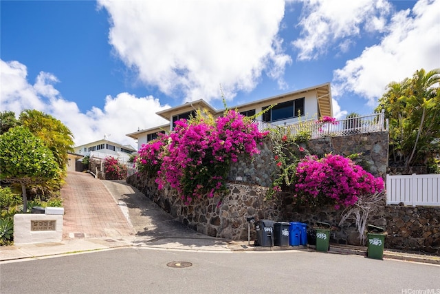 5333 Puahia Pl, Honolulu, HI 96821 - view of front of property featuring driveway and stone siding