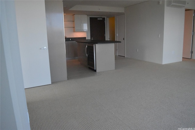1200 Queen Emma St Unit 3511, Honolulu, HI 96813 - kitchen with an AC wall unit, light colored carpet, white cabinetry, dark countertops, and washer / clothes dryer